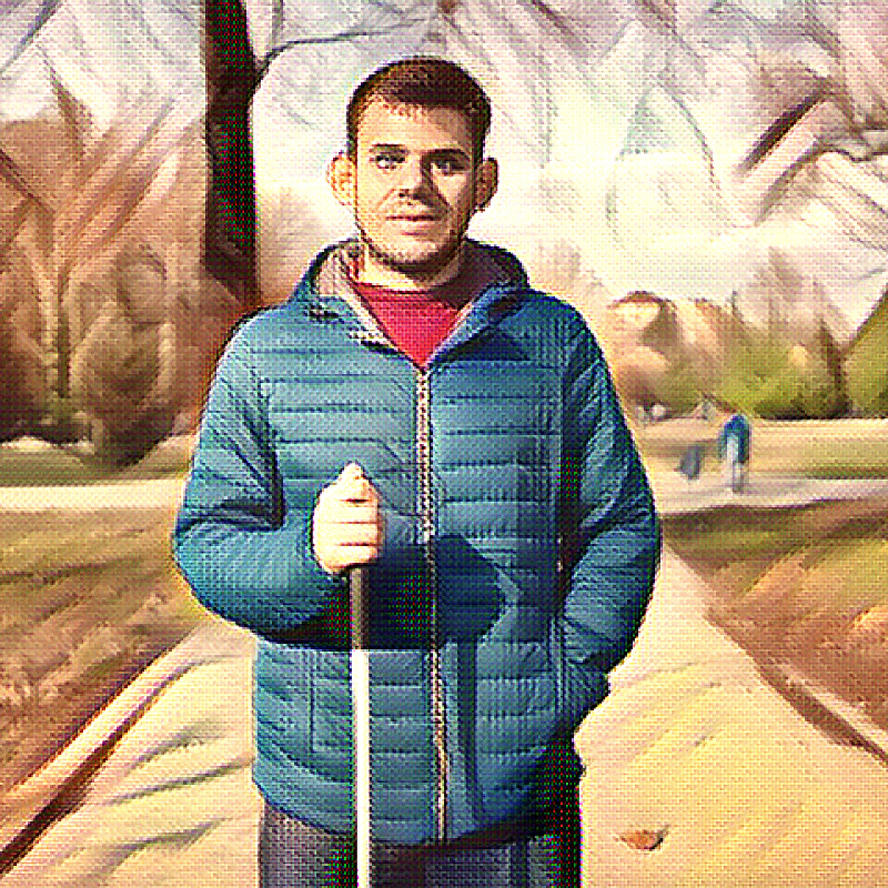 A young man standing with a stick in a park